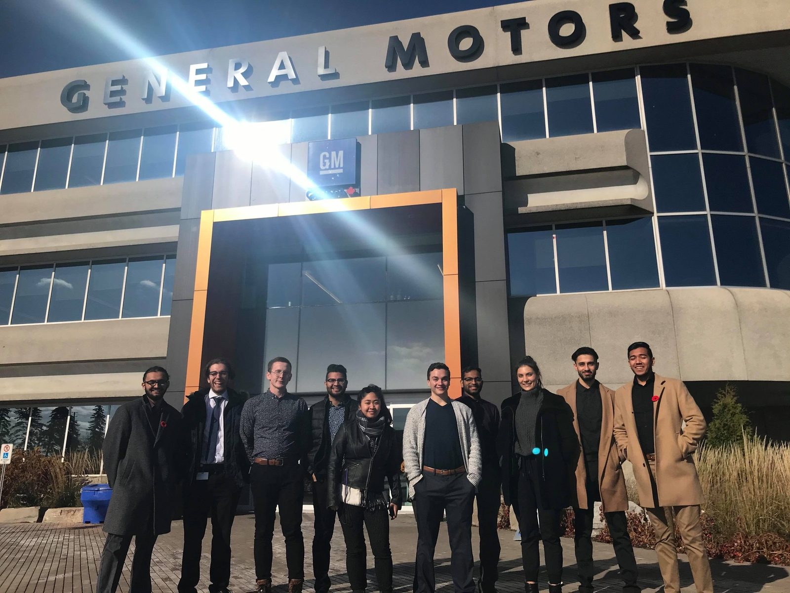 The professional internship cohort standing in front of the General Motors Canada headquarters building