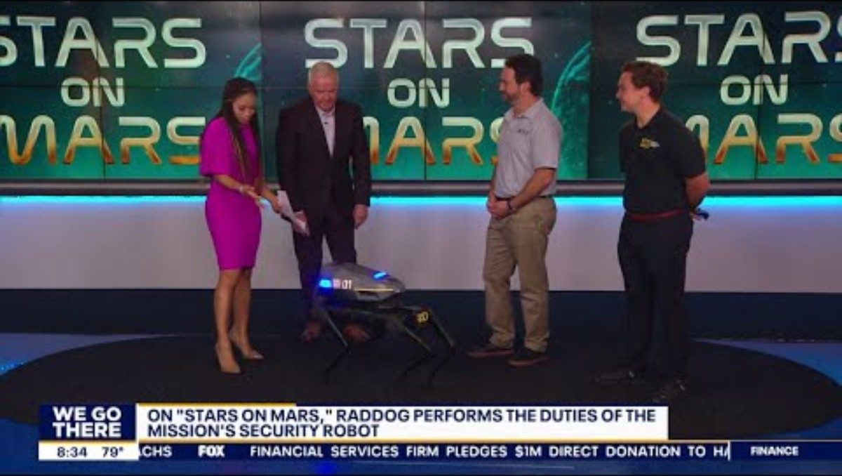 RADDOG quadruped robot center stage on the Good Day Philadelphia studio floor with the hosts standing around it