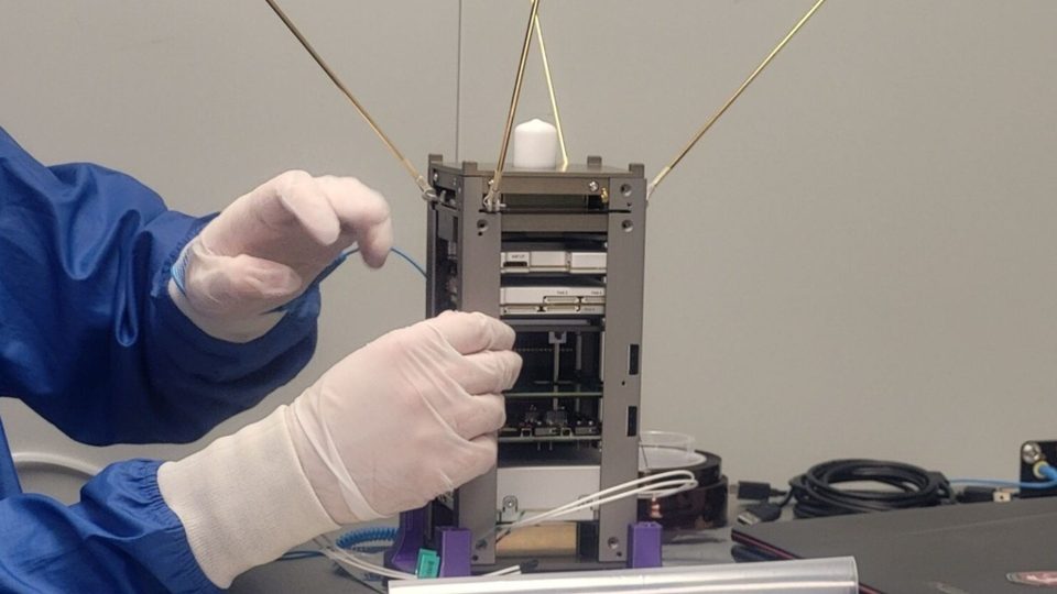 UKPIK-1 CubeSat being assembled with gloved hands at Western University