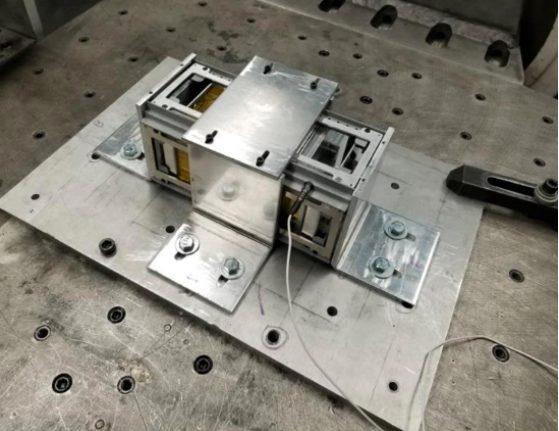 CubeSat structure mounted to a vibration test fixture plate